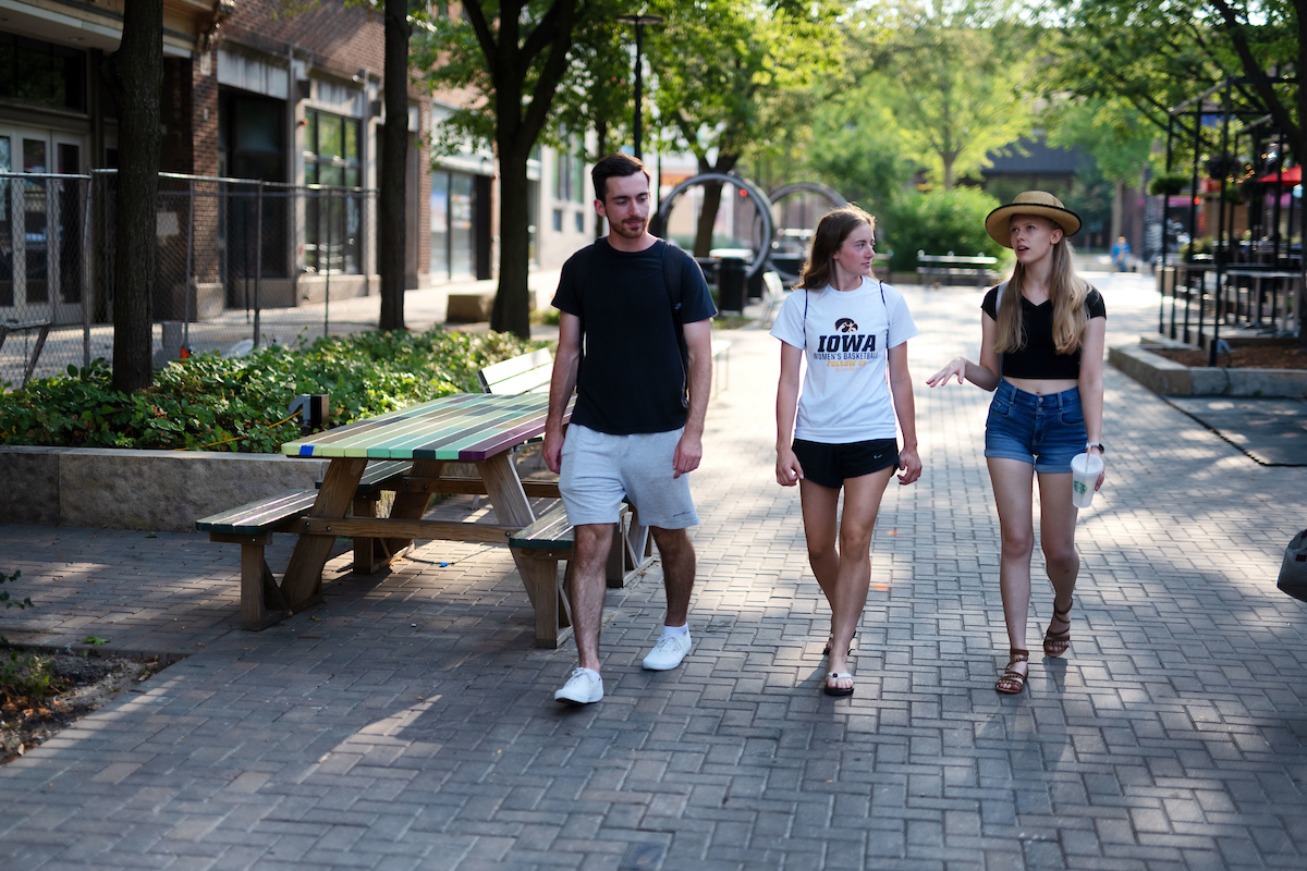 People enjoying the ped mall in downtown Iowa City.