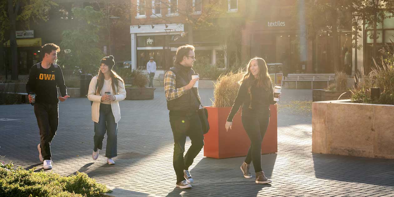 People enjoying the ped mall in downtown Iowa City.