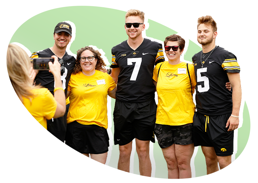 Iowa Hawkeyes football players take a photo during the final Iowa Ladies Football Academy